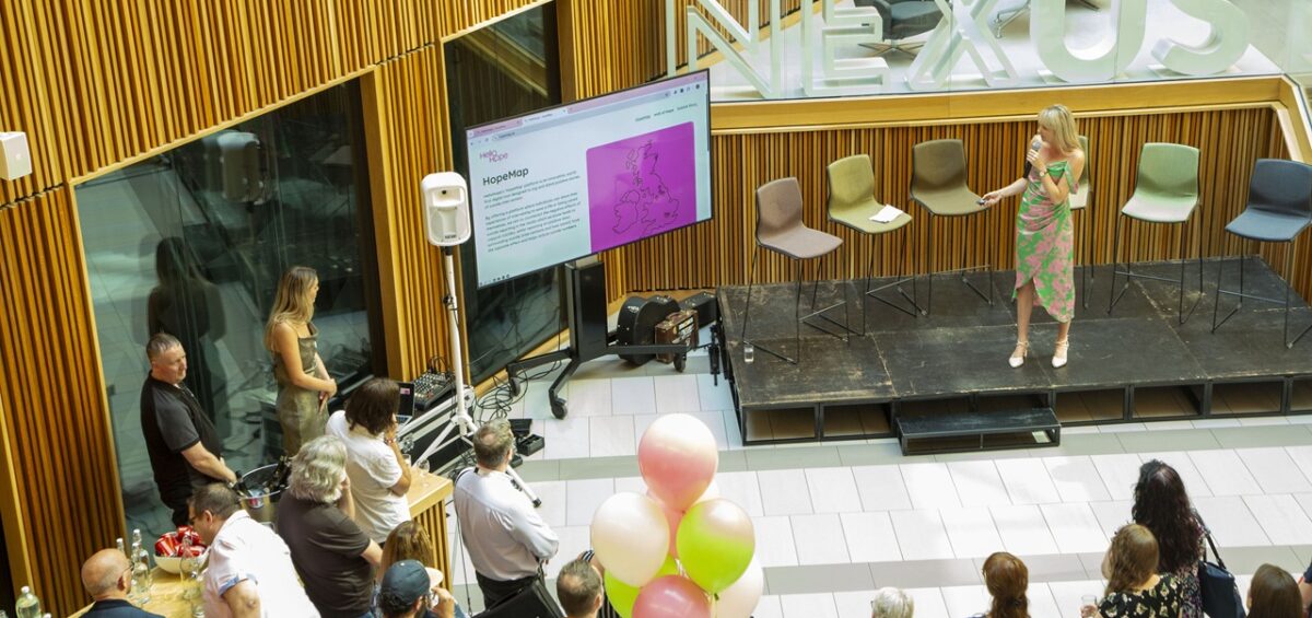 Attendees of A Celebration of Hope event watch the HopeMap become unveiled