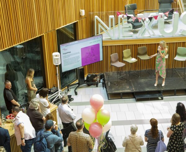 Attendees of A Celebration of Hope event watch the HopeMap become unveiled